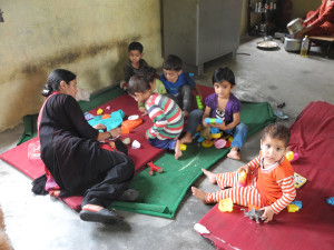 Ravindra spends a little time chatting with the kids who are enjoying their new building blocks. We really need lots more of this kind of toy.