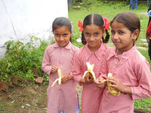 The children enjoy their bananas.